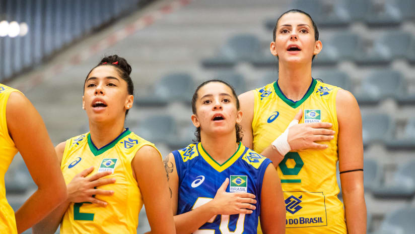 Leticia Moura (in the middle) sings her national anthem with her teammates