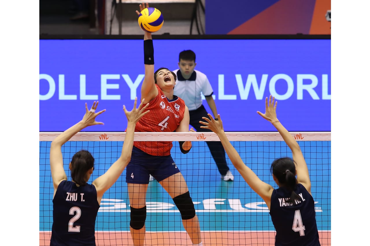 Kim Heejin strikes above the China block at the 2019 FIVB Volleyball Nations League.