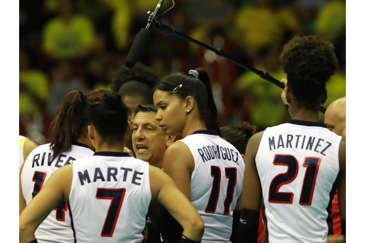 Dominican players get instructions from coach Marcos Kwiek during a timeout at the 2019 FIVB Volleyball Nations League.
