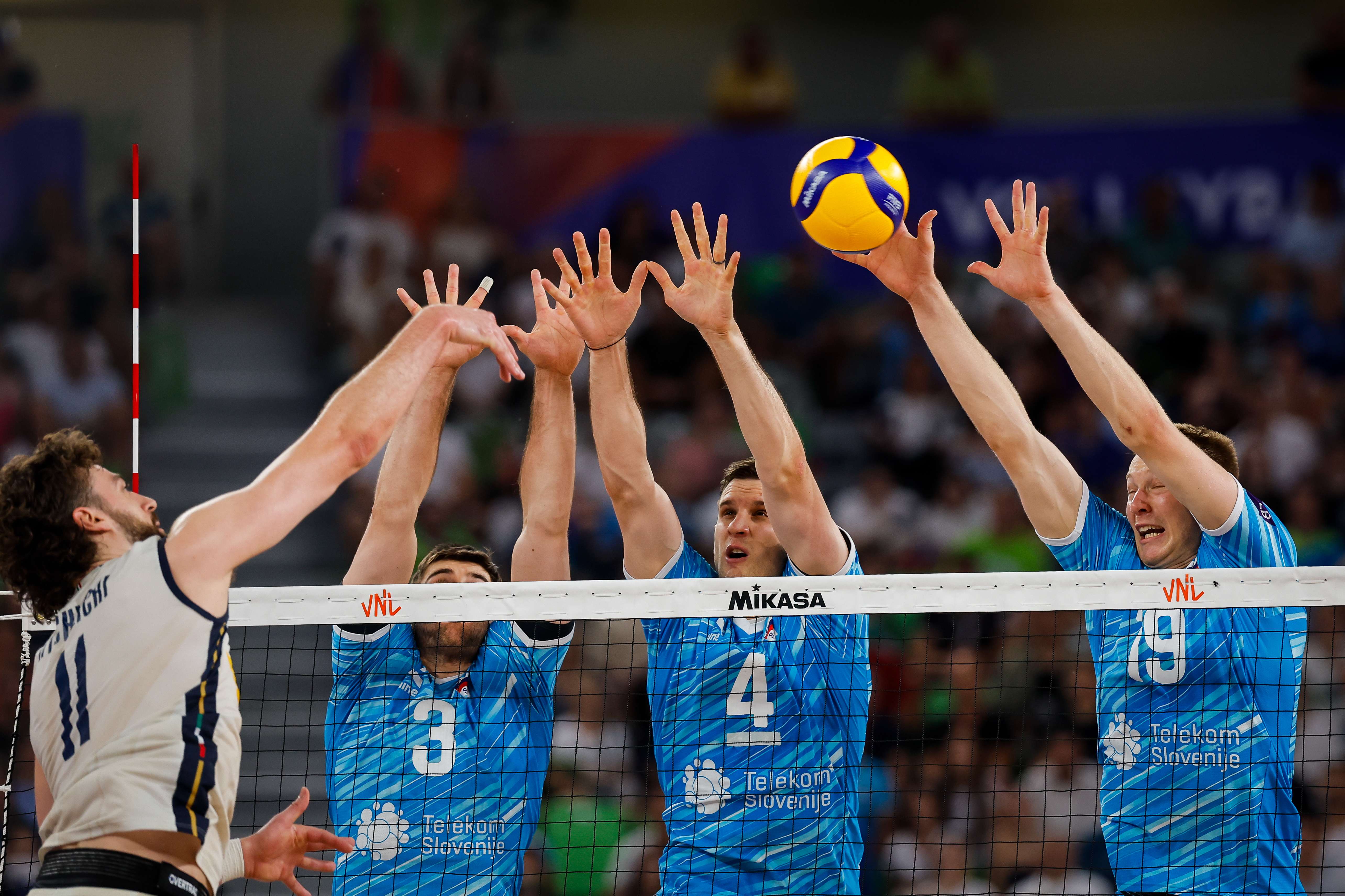 Italy’s Kamil Rychlicki against a three-man Slovenian block