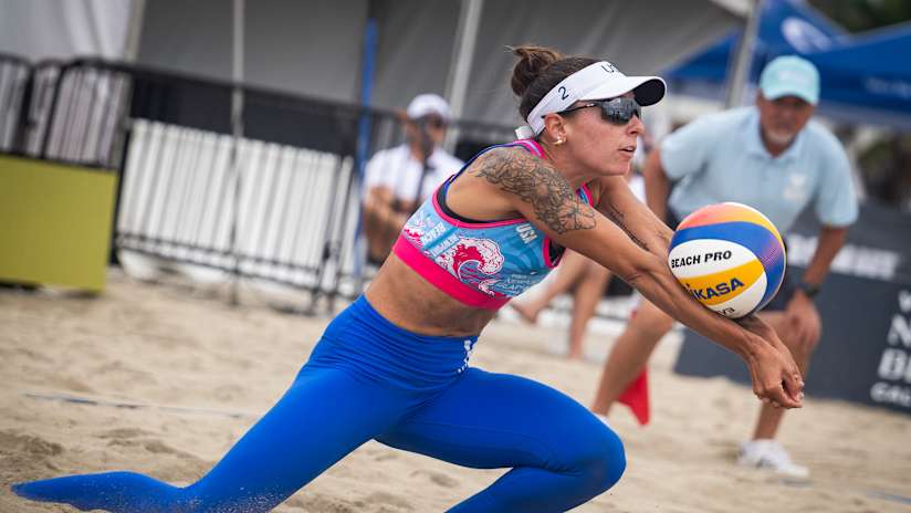 Molly Shaw digs during a beach volleyball match