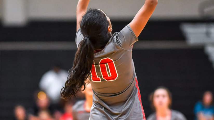 A volleyball player setting the ball during a volleyball game