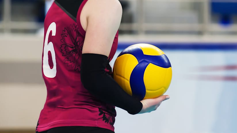 A volleyball player getting ready to serve