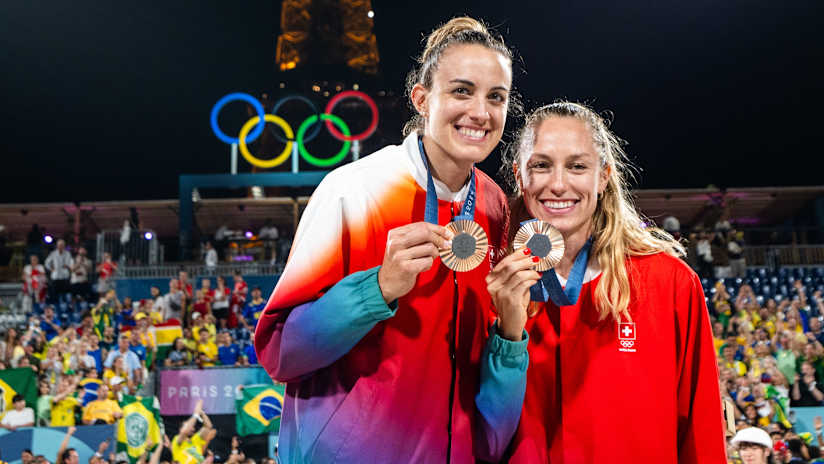 Hüberli and Brunner pose with their Olympic medals at the Eiffel Tower Stadium