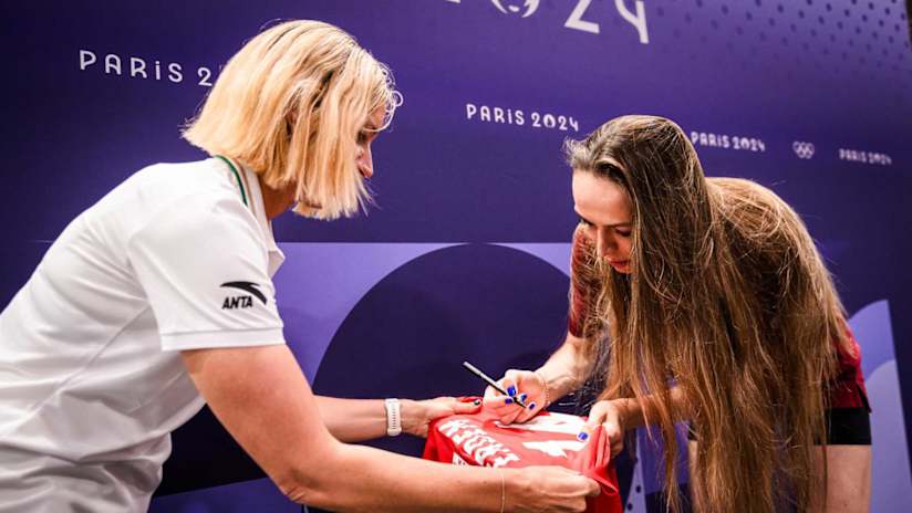 Eda Erdem signs her jersey before handing it in to history