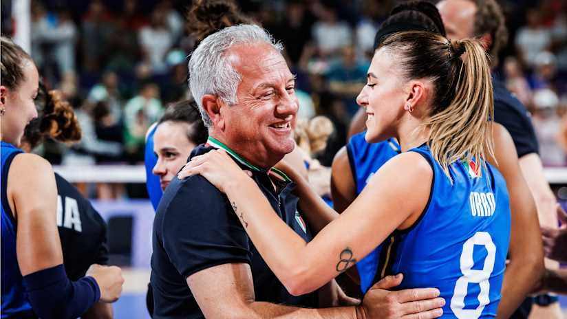 Head coach Julio Velasco hugs setter Alessia Orro after Italy's victory over the United States in the gold medal match