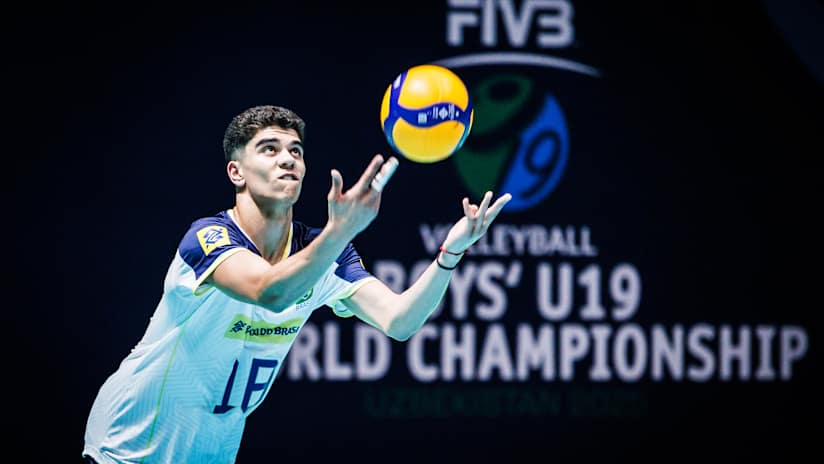 Lucas Rigui focusing while serving the ball