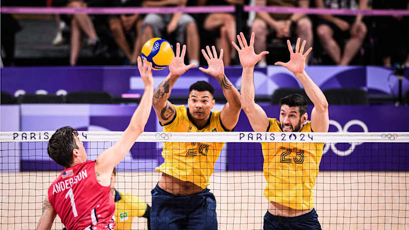 USA's Matt Anderson tips the ball over two Brazilian blockers