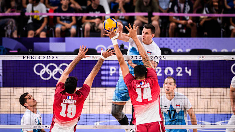 Middle blocker Jan Kozamernik spikes against the French