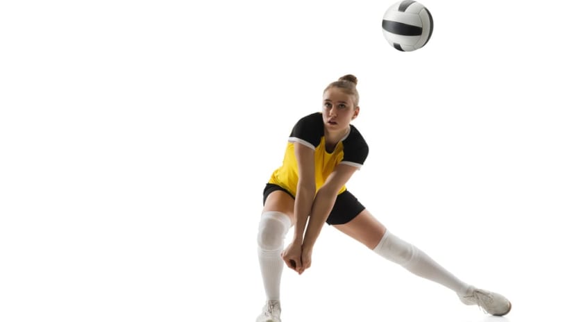 A female volleyball player receiving a ball