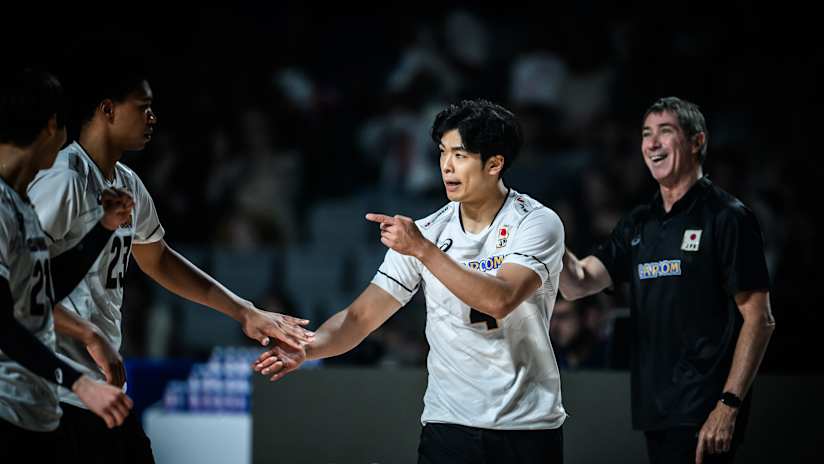 Japan players celebrating a point against Slovenia.
