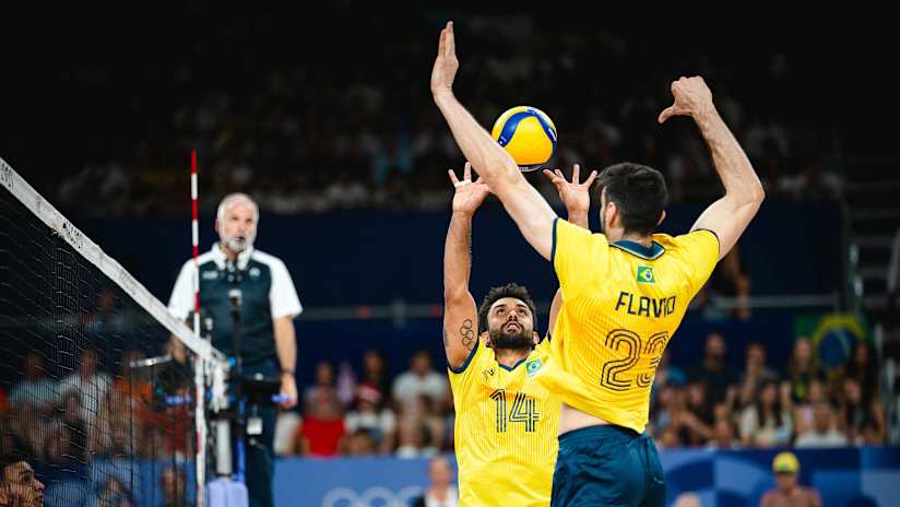 Setter Fernando 'Cachopa' Kreling works with middle blocker Flavio Gualberto at the net