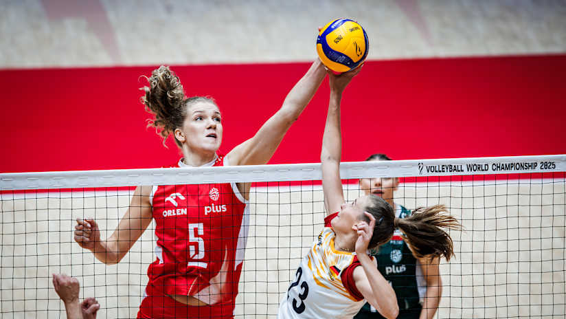 Poland`s Agnieszka Korneluk and Germany`s Sarah Straube joust at the net