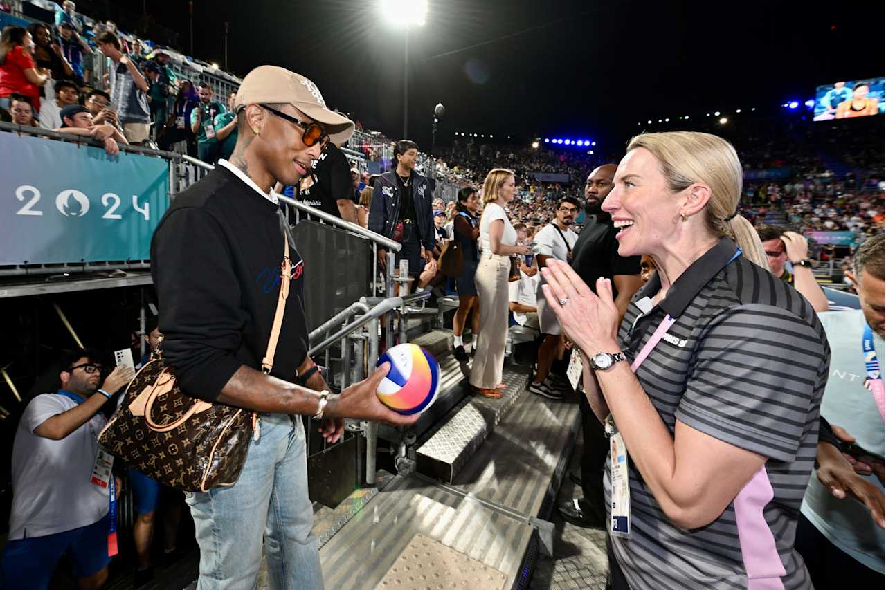 American singer, songwriter, rapper and record producer Pharrell Williams with FIVB Athlete Ambassador Louise Bawden at Paris 2024 Beach Volleyball