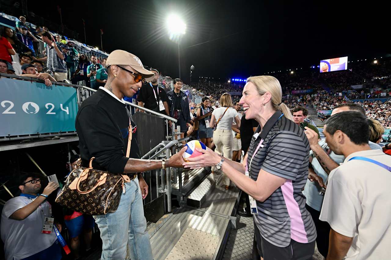 American singer, songwriter, rapper and record producer Pharrell Williams with FIVB Athlete Ambassador Louise Bawden at Paris 2024 Beach Volleyball