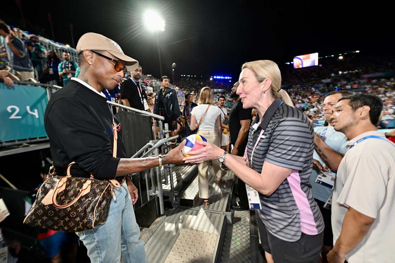 American singer, songwriter, rapper and record producer Pharrell Williams with FIVB Athlete Ambassador Louise Bawden at Paris 2024 Beach Volleyball